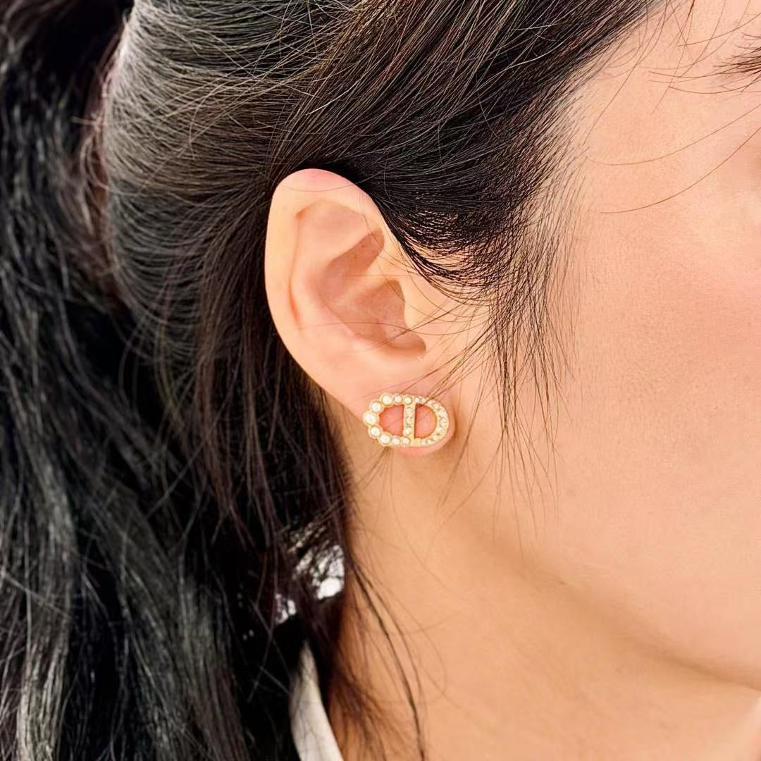 Martin Graham stud earrings in polished metal-tone – side detail