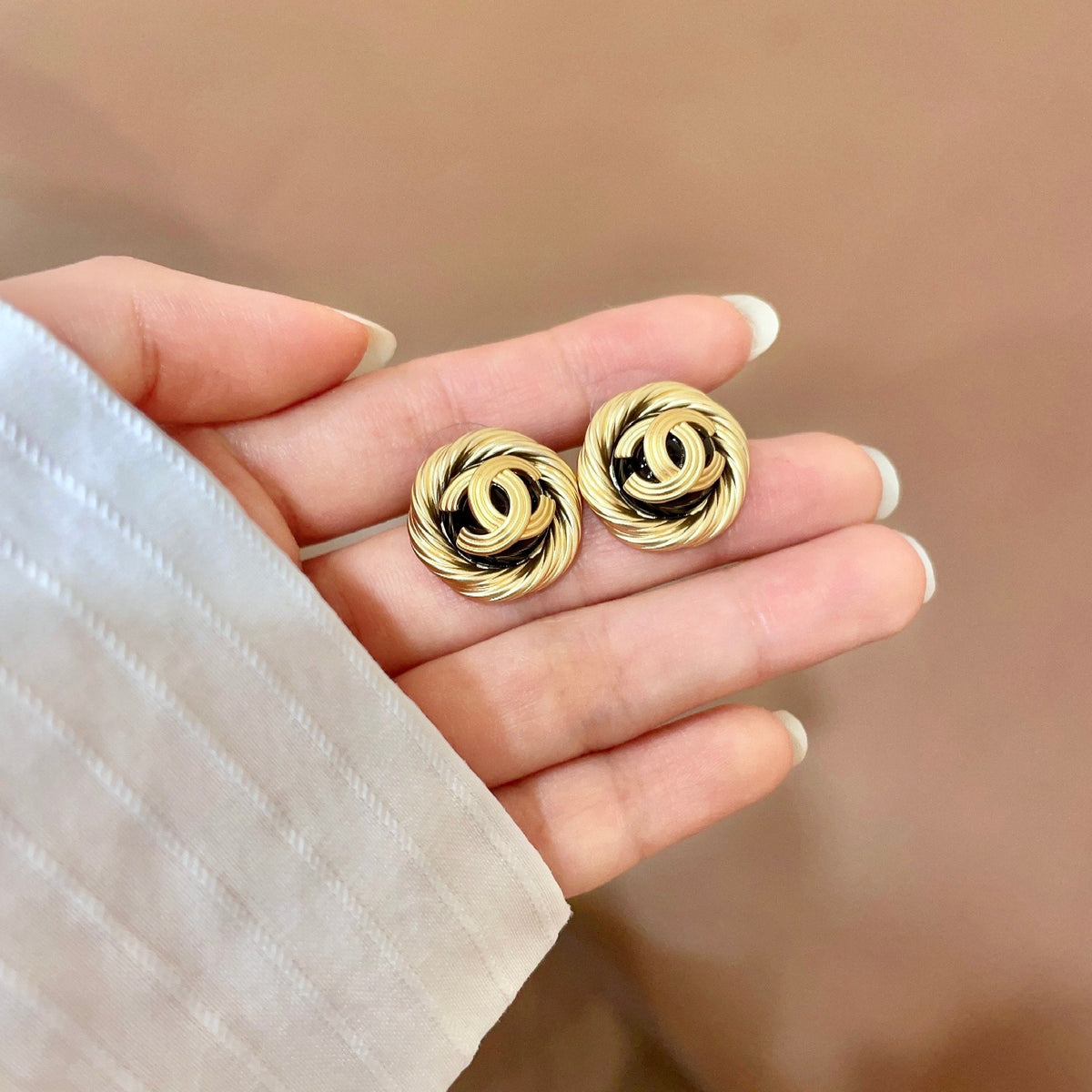 Martin Graham stud earrings in polished metal-tone – side detail