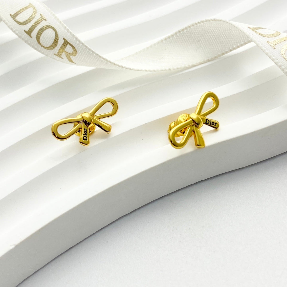 Martin Graham stud earrings in polished metal-tone – side detail