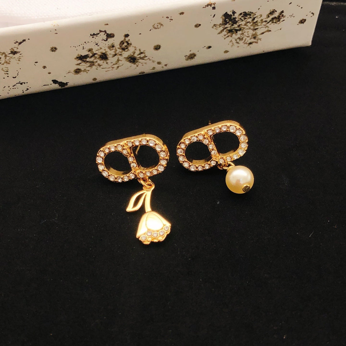 Martin Graham stud earrings in polished metal-tone – side detail