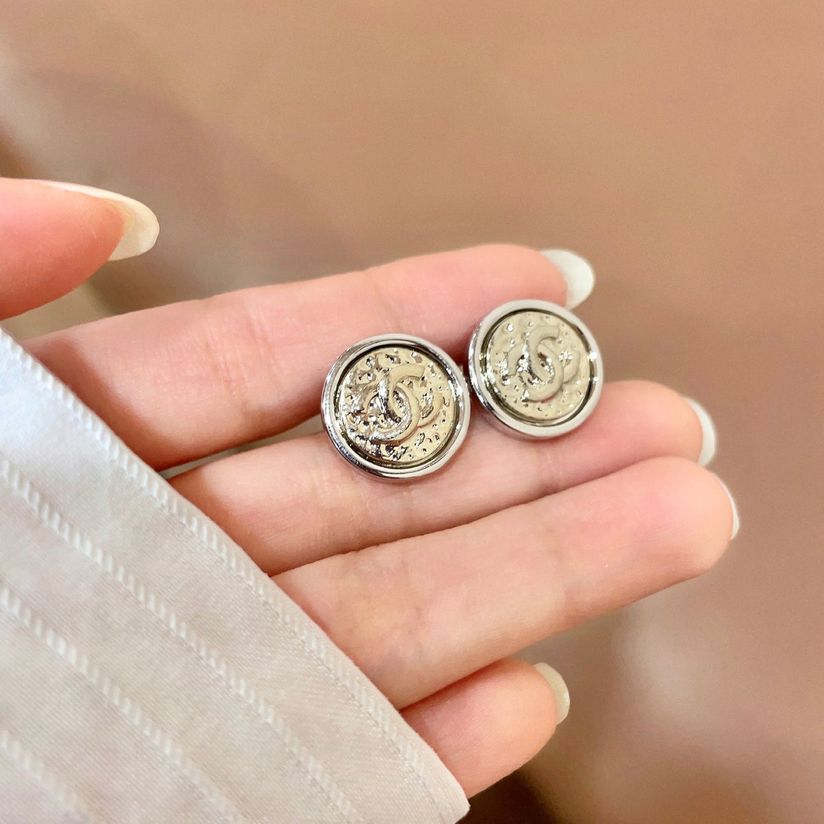 Martin Graham stud earrings in polished metal-tone – side detail