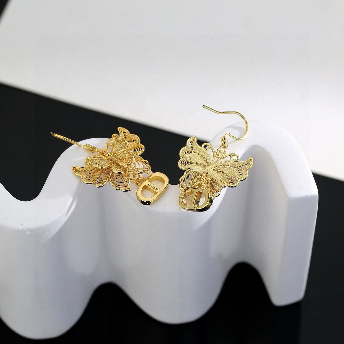 Martin Graham stud earrings in polished metal-tone – side detail