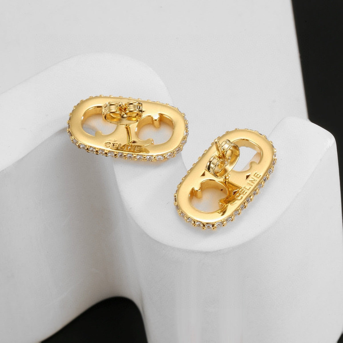 Martin Graham stud earrings in polished metal-tone – side detail