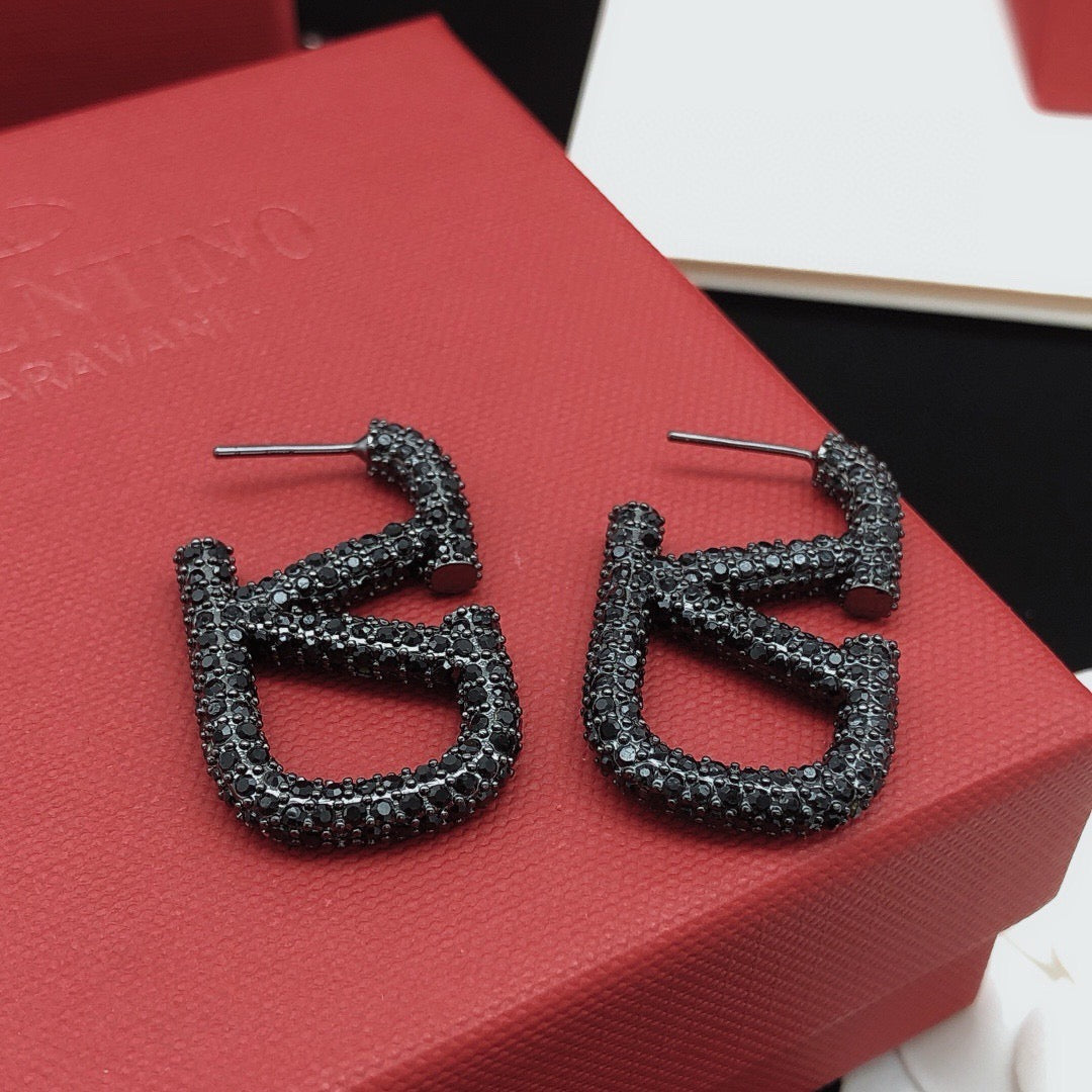 Martin Graham stud earrings in polished metal-tone – side detail