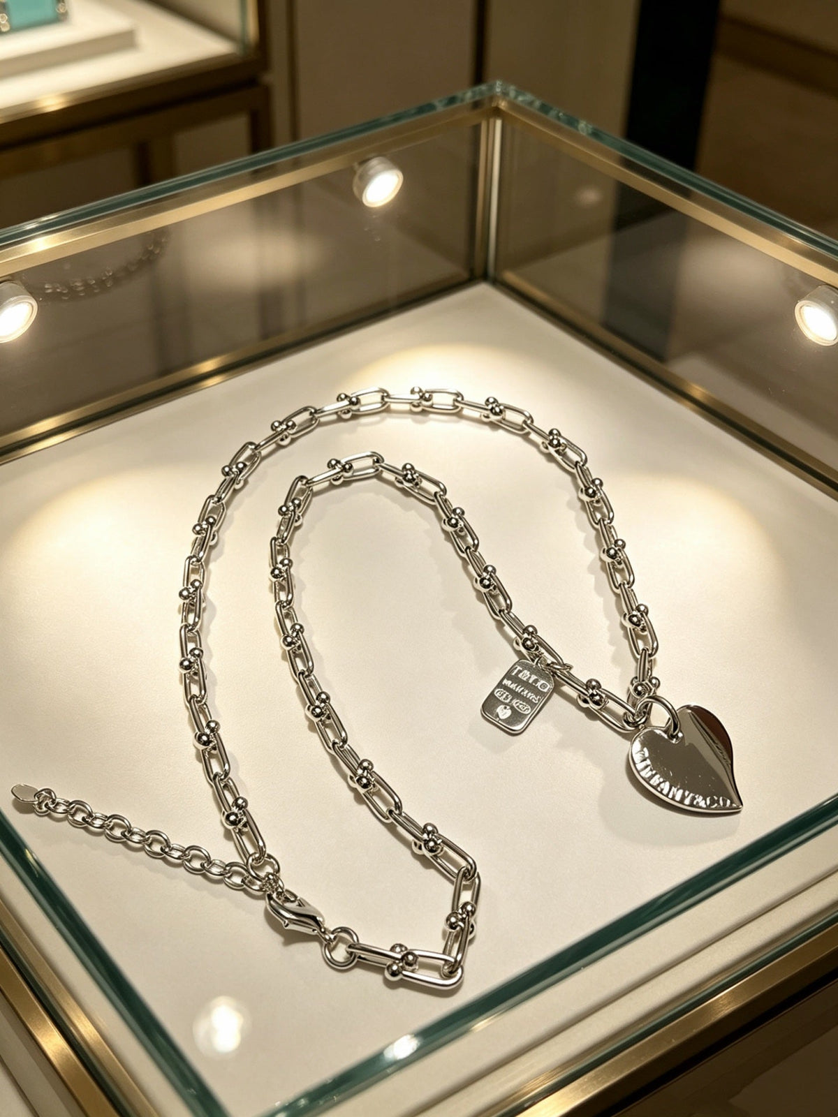 Martin Graham pendant necklace in polished metal-tone – side detail