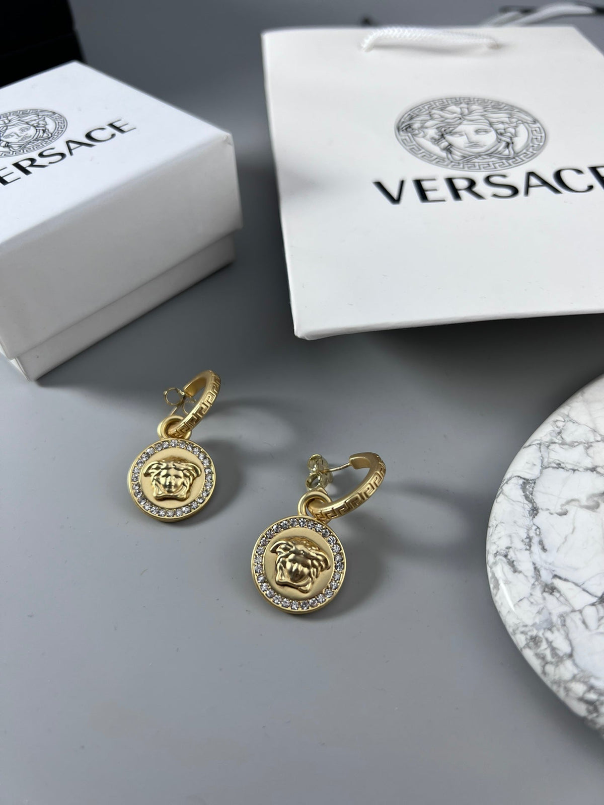 Martin Graham stud earrings in polished metal-tone – styled product view