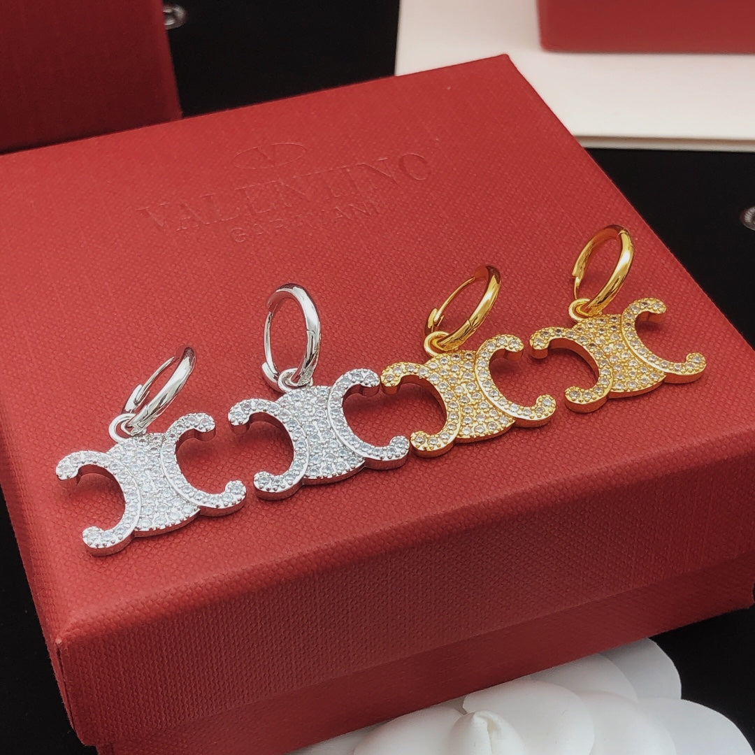 Martin Graham drop earrings in polished metal-tone