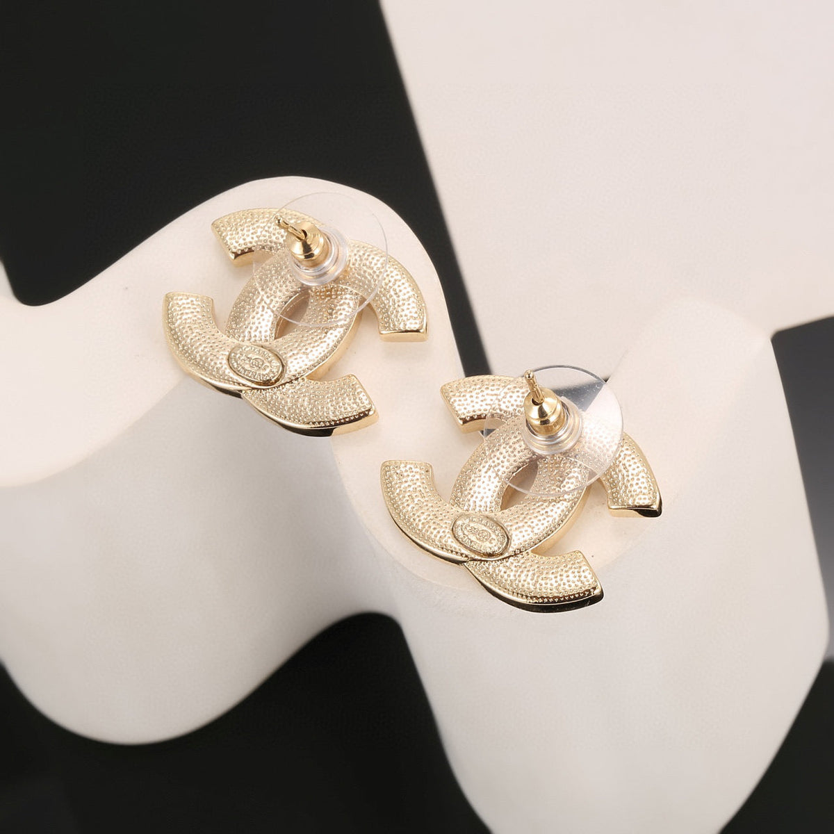 Martin Graham stud earrings in polished metal-tone – close-up detail