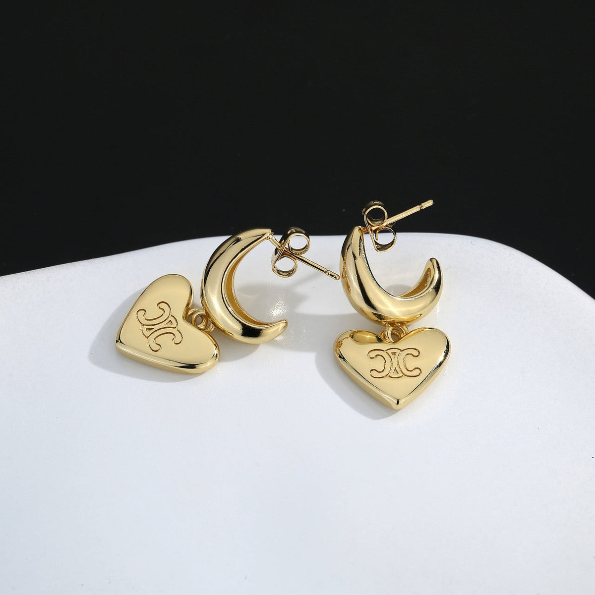 Martin Graham stud earrings in polished metal-tone