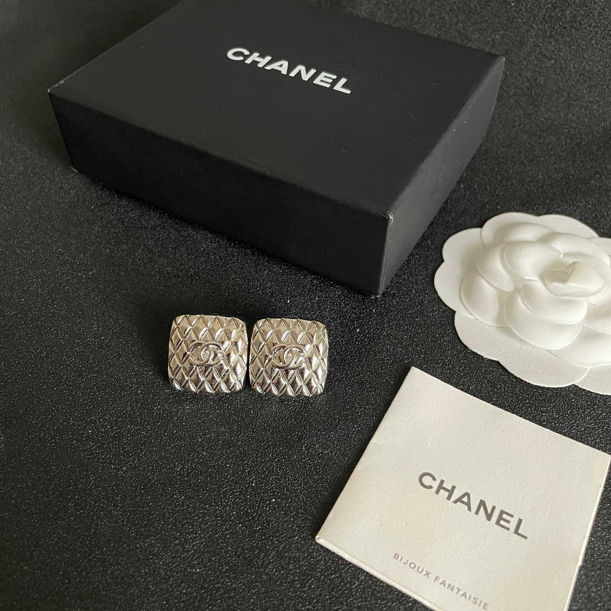 Martin Graham stud earrings in polished metal-tone – close-up detail