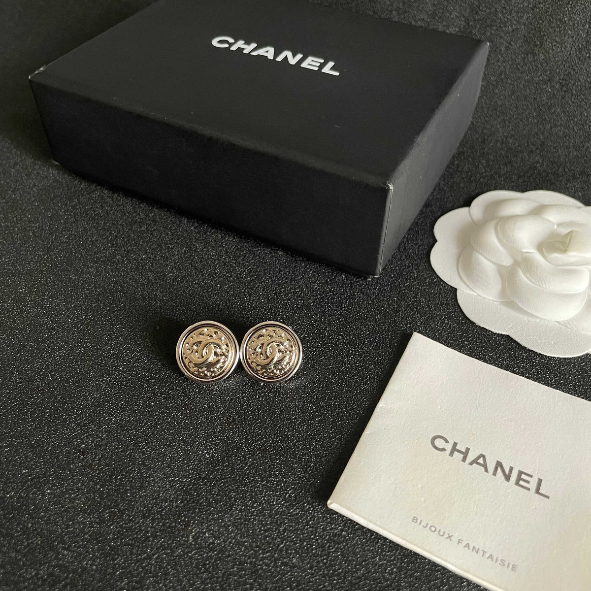 Martin Graham stud earrings in polished metal-tone – close-up detail
