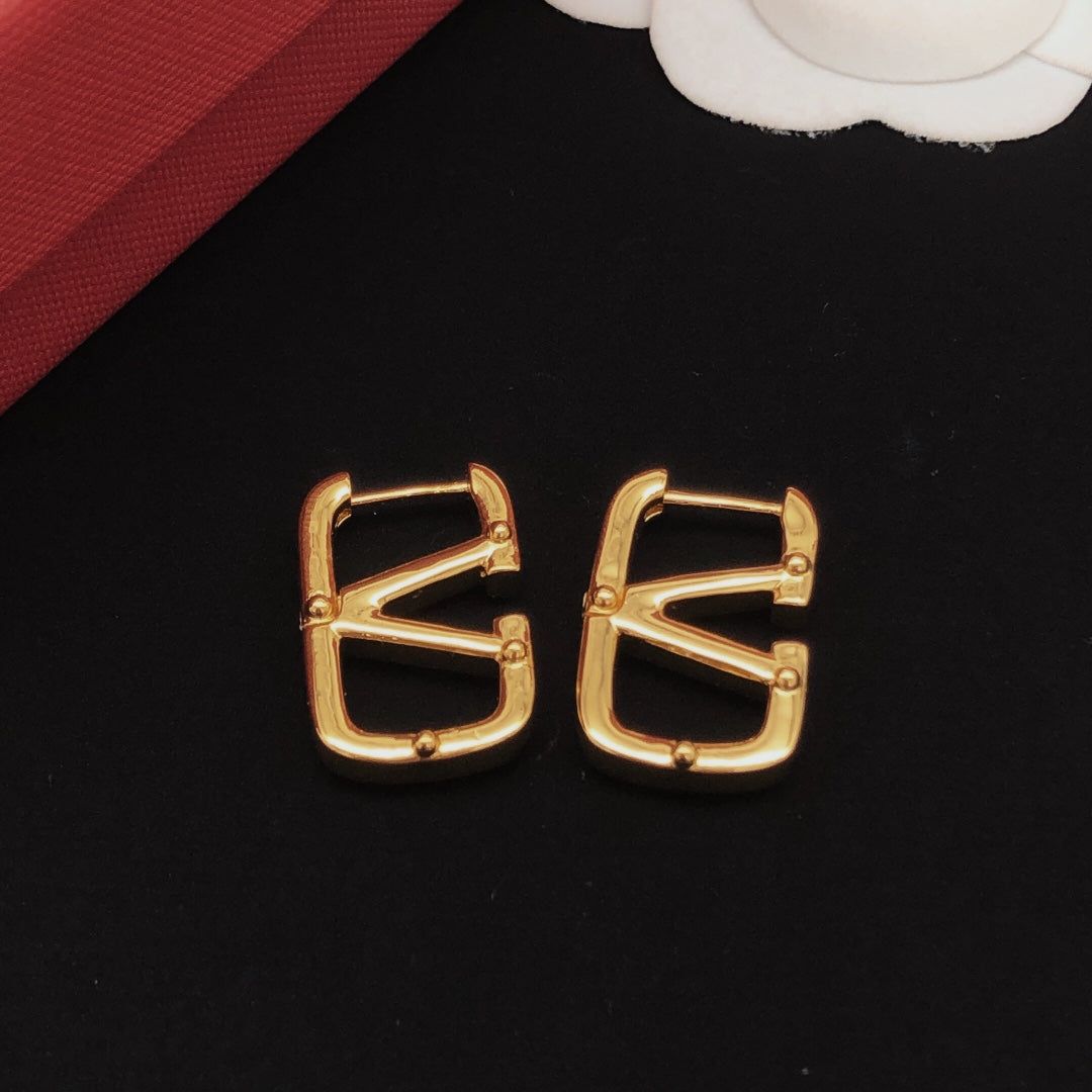 Martin Graham drop earrings in polished metal-tone