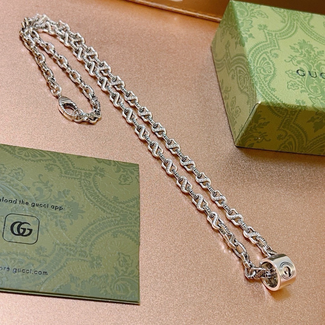 Martin Graham pendant necklace in polished metal-tone – close-up detail