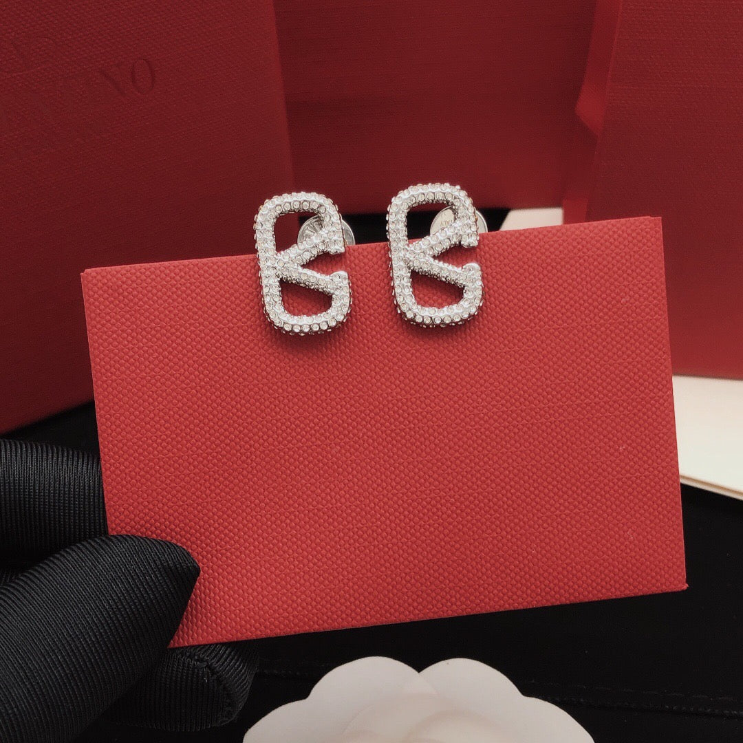 Martin Graham stud earrings in polished metal-tone