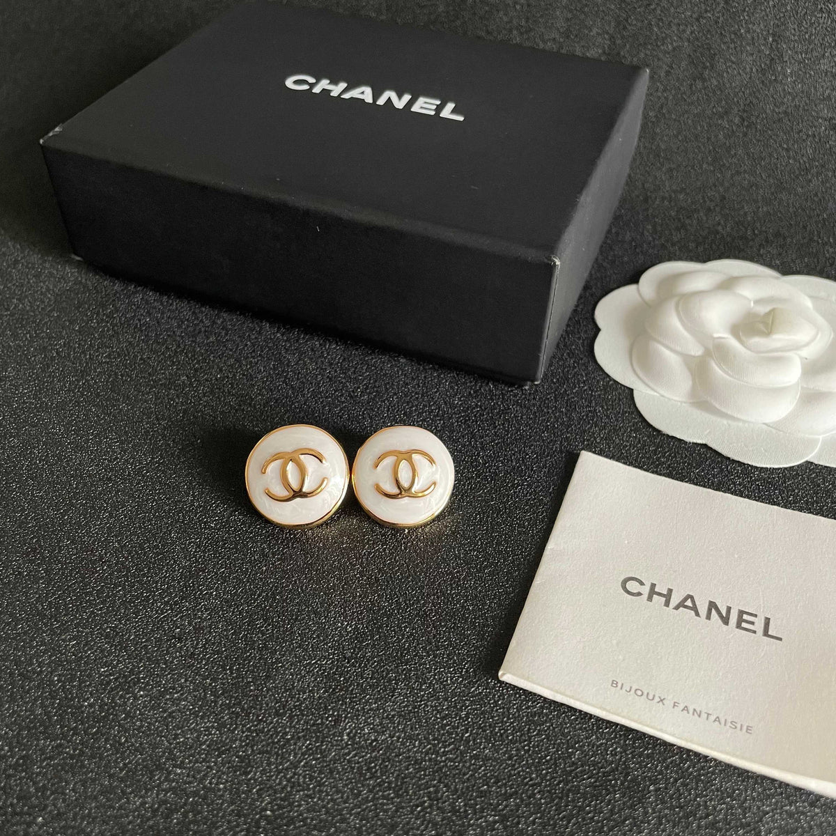 Martin Graham stud earrings in polished metal-tone – close-up detail