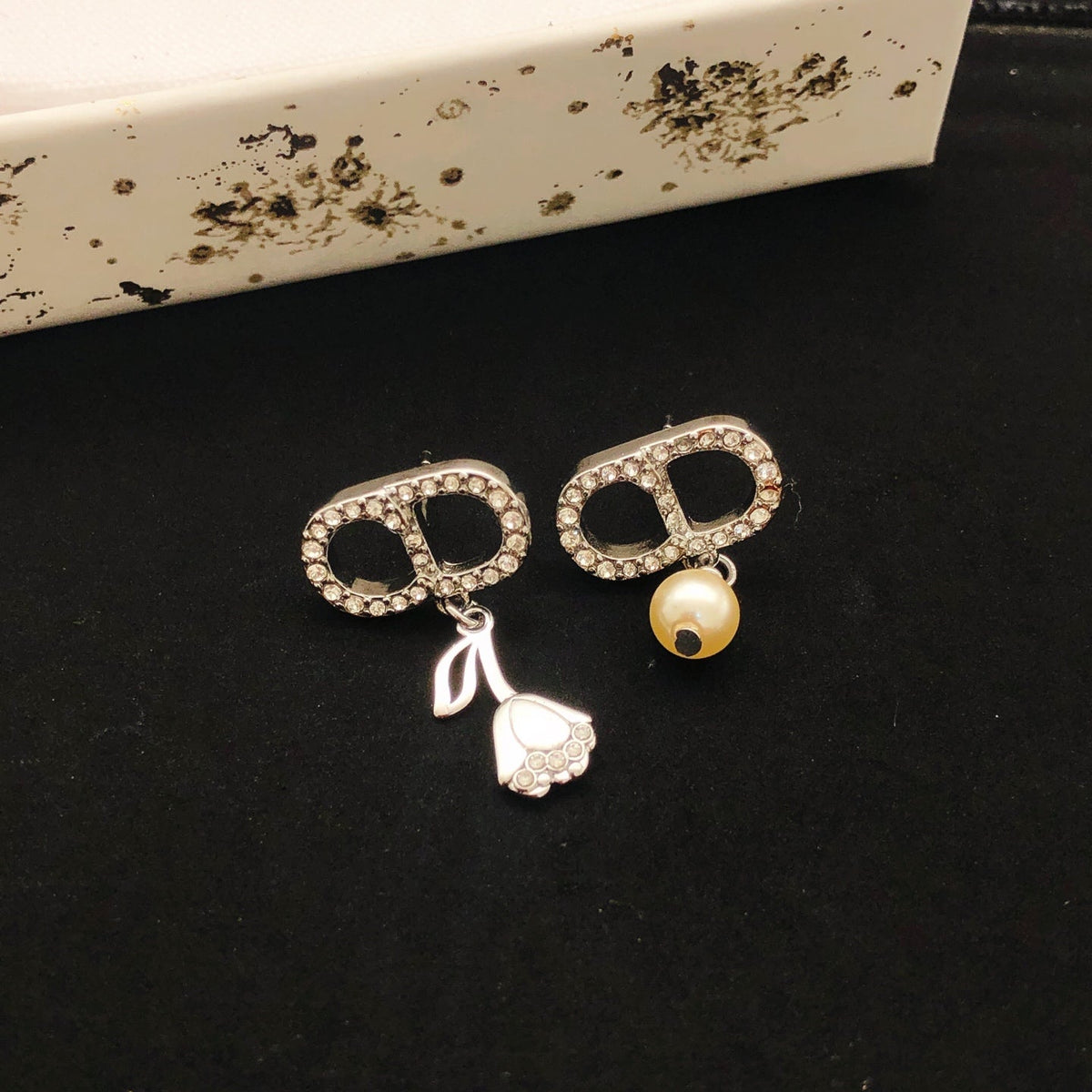Martin Graham stud earrings in polished metal-tone – close-up detail