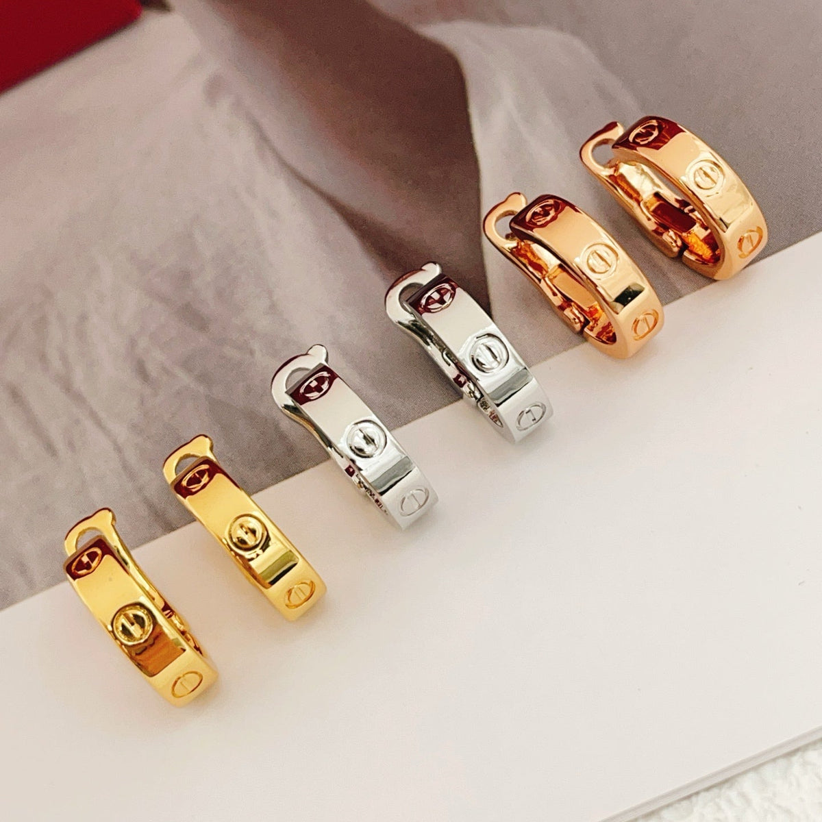 Martin Graham stud earrings in polished metal-tone – close-up detail