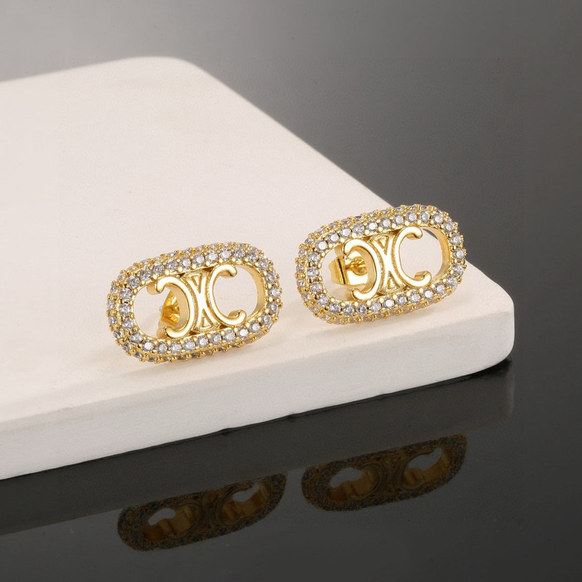 Martin Graham stud earrings in polished metal-tone