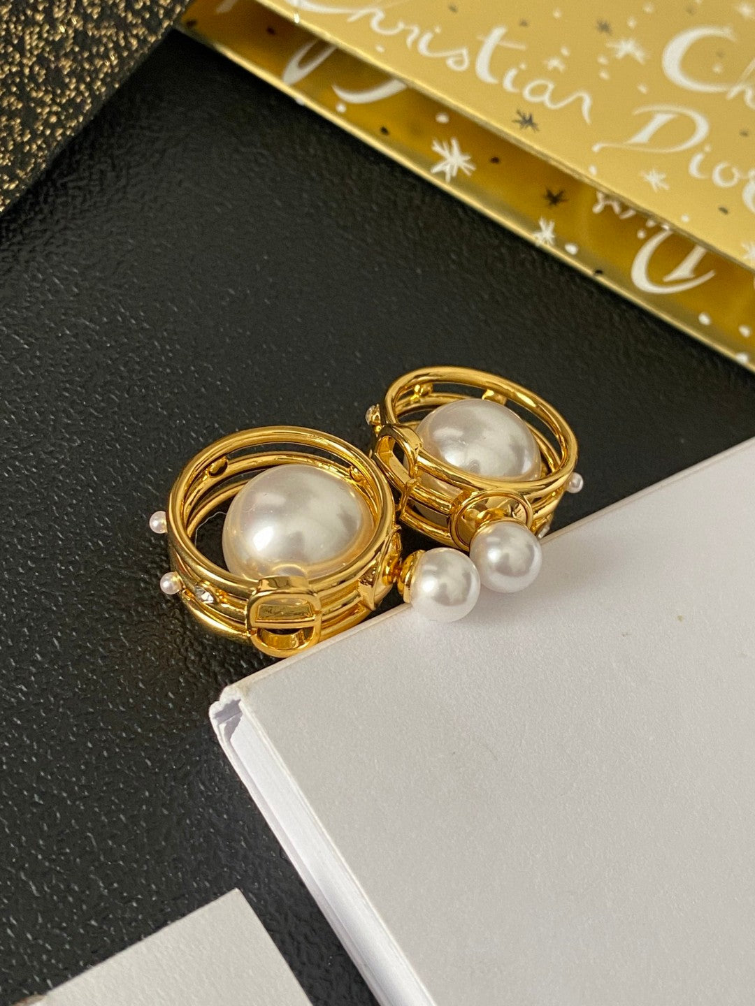 Martin Graham earrings in polished metal-tone – close-up detail