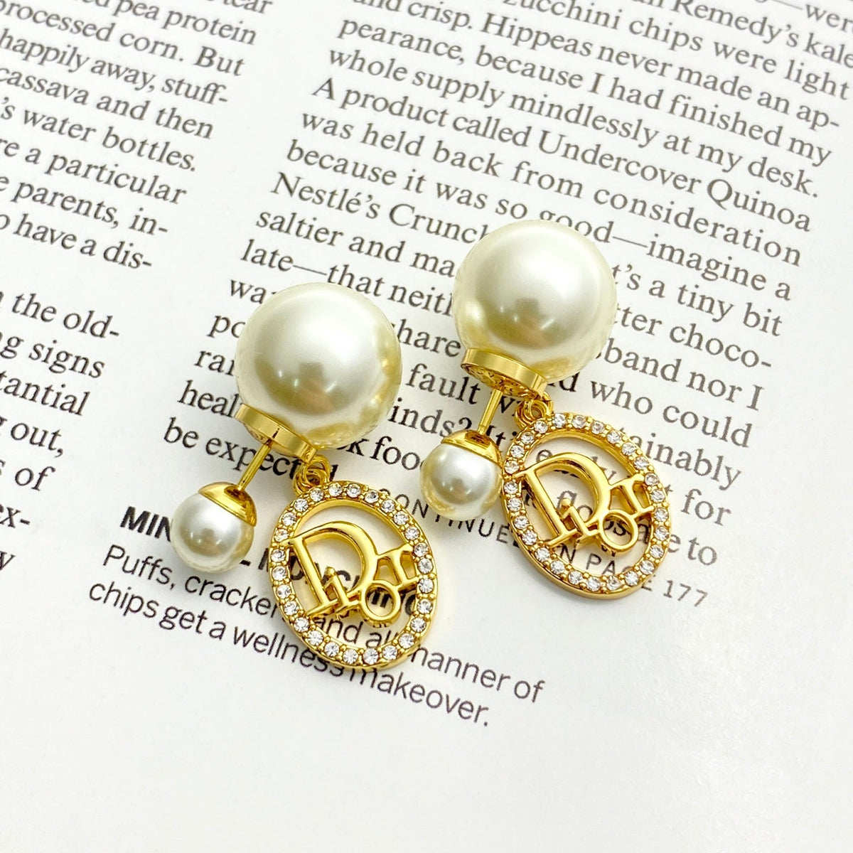 Martin Graham stud earrings in polished metal-tone – close-up detail