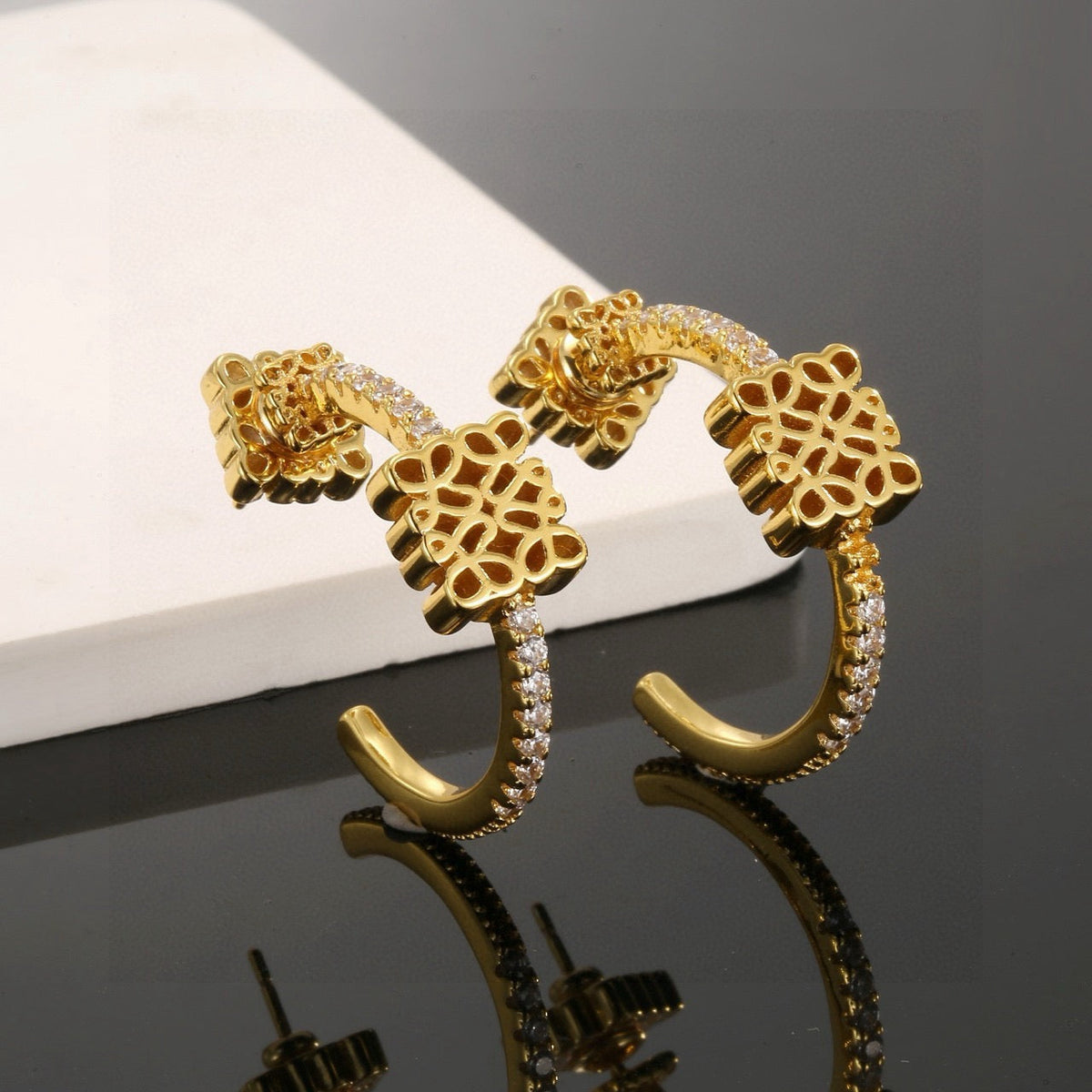 Martin Graham stud earrings in polished metal-tone – close-up detail
