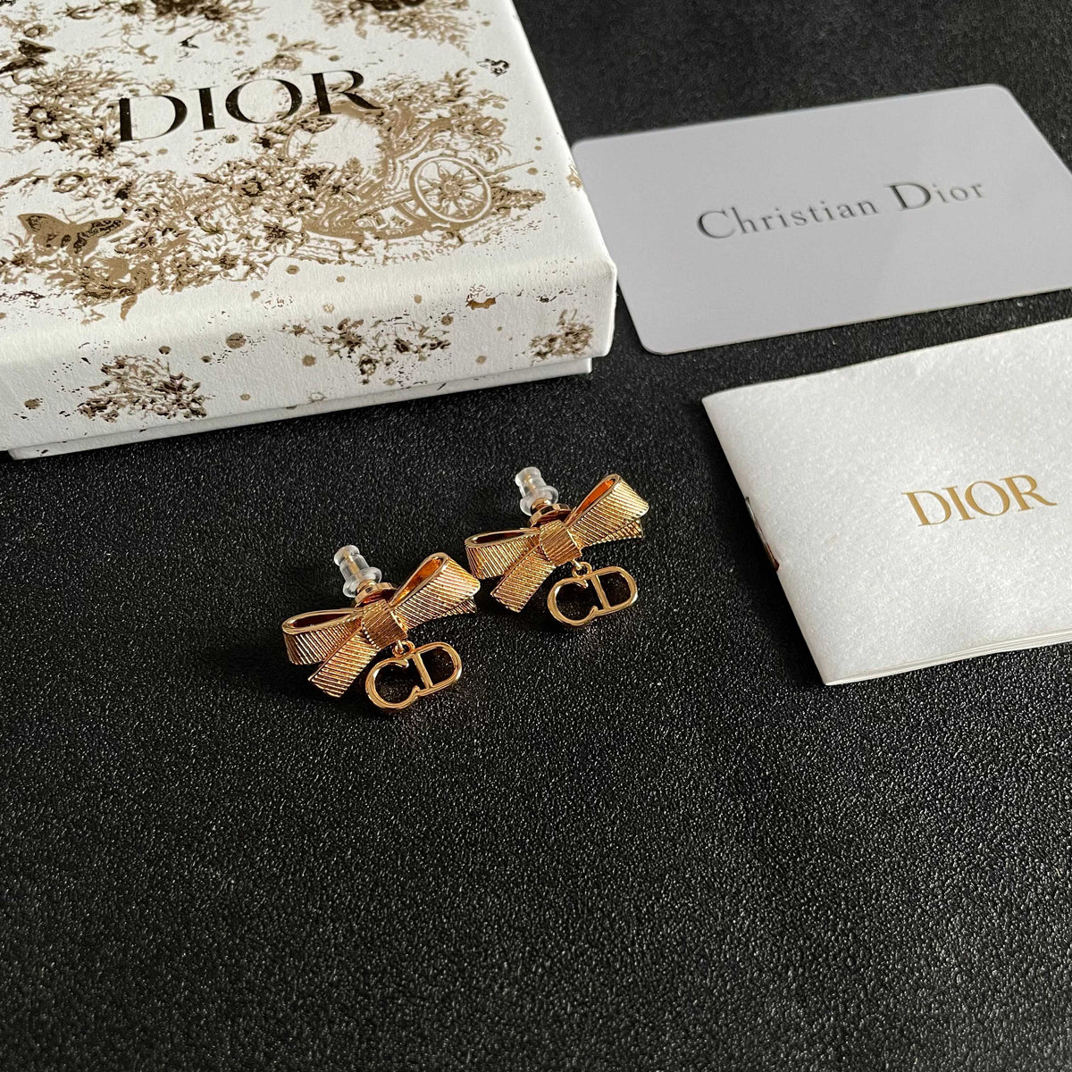 Martin Graham stud earrings in polished metal-tone – close-up detail
