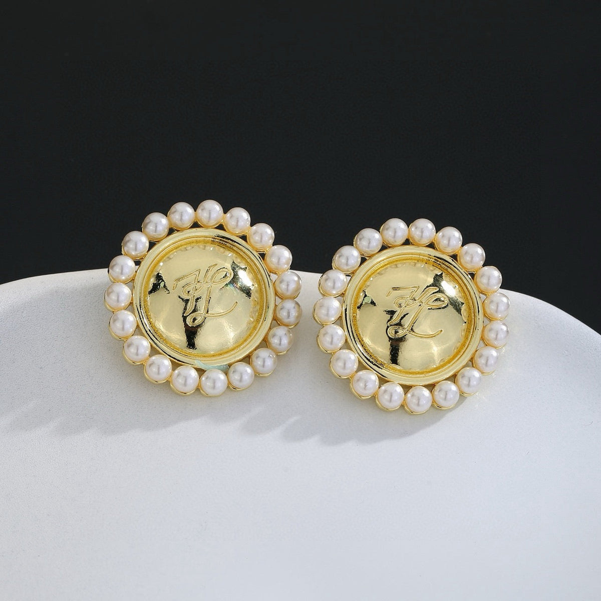 Martin Graham stud earrings in polished metal-tone – close-up detail