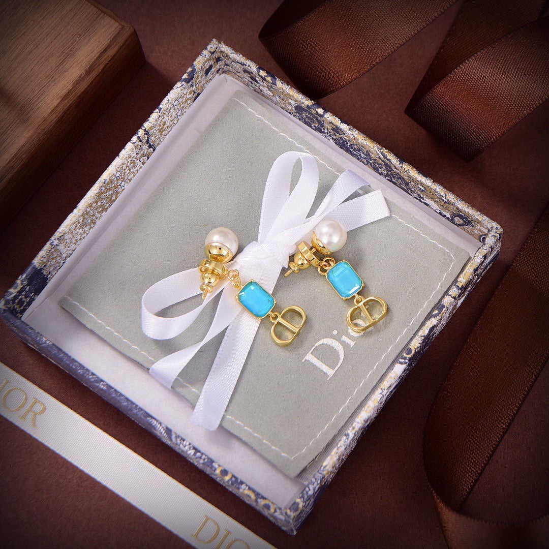 Martin Graham stud earrings in polished metal-tone – close-up detail