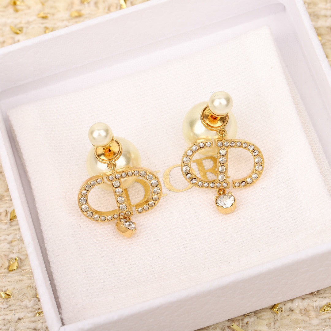 Martin Graham stud earrings in polished metal-tone – close-up detail