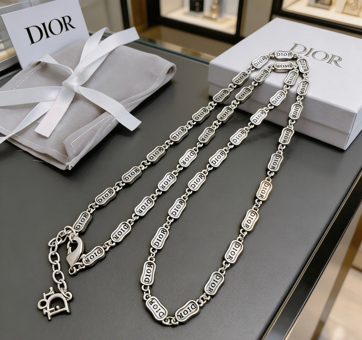 Martin Graham pendant necklace in polished metal-tone – close-up detail