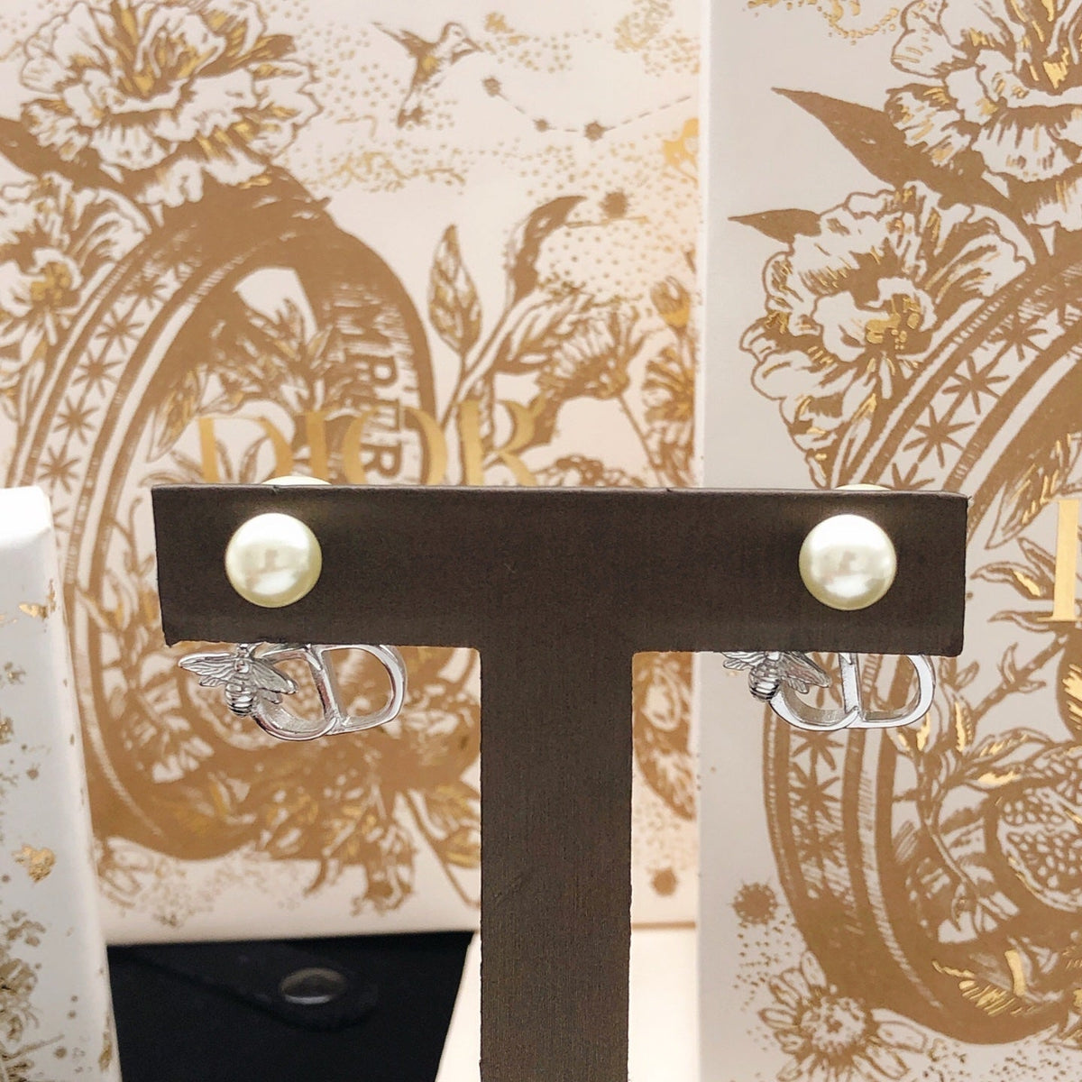 Martin Graham stud earrings in polished metal-tone – close-up detail