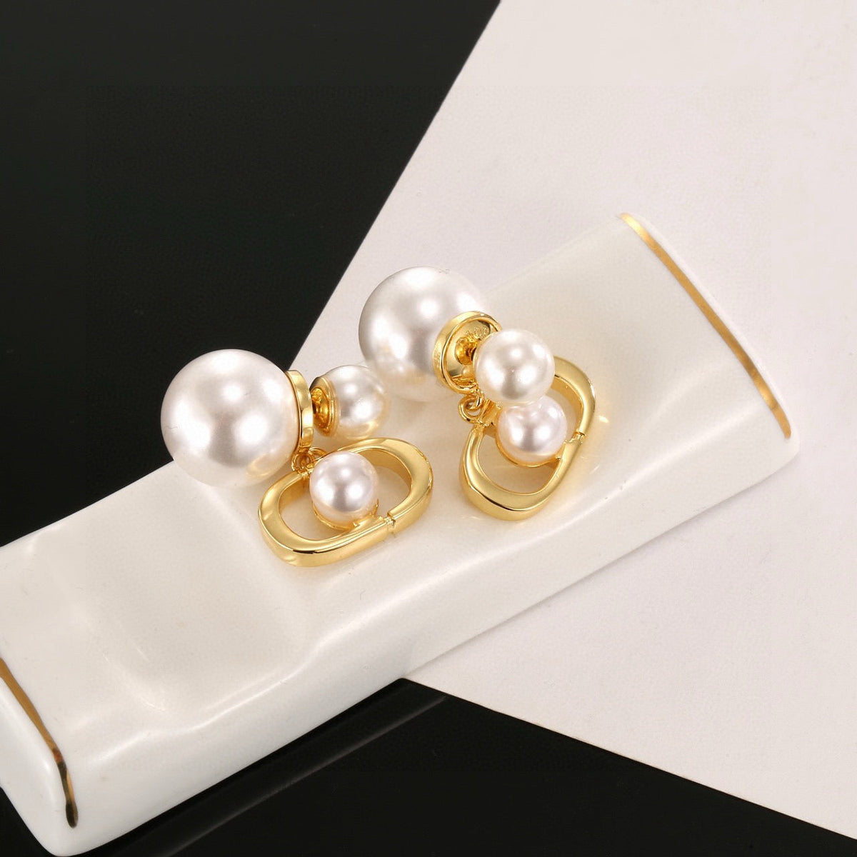 Martin Graham earrings in polished metal-tone – close-up detail