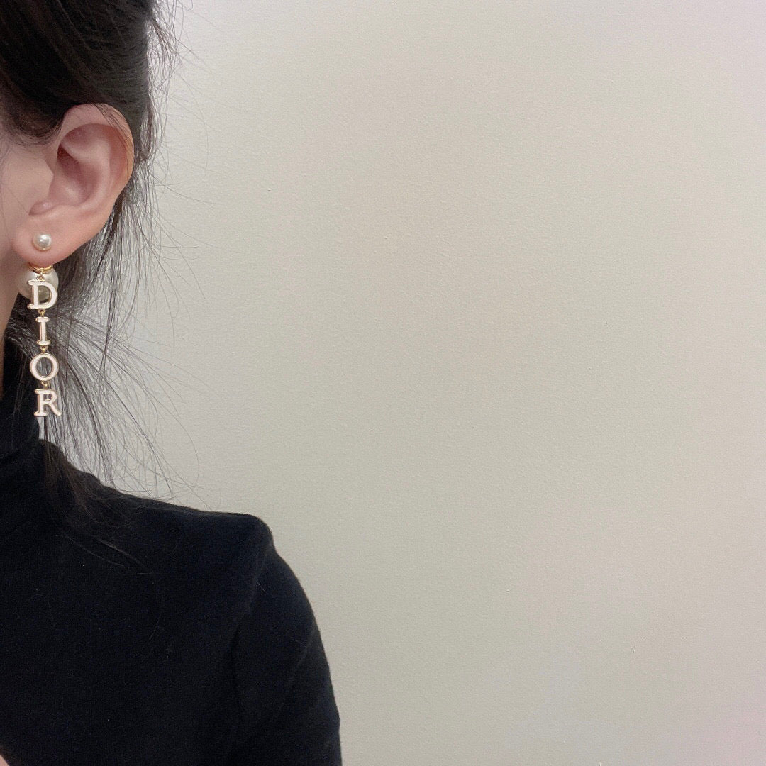Martin Graham stud earrings in polished metal-tone – close-up detail