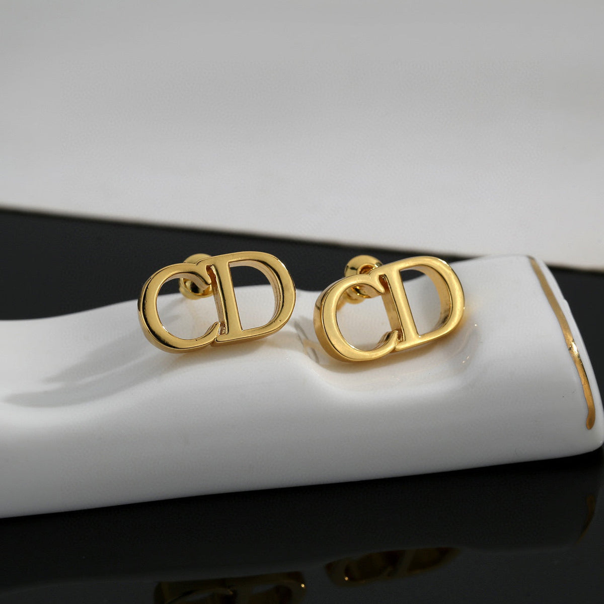 Martin Graham earrings in polished metal-tone – close-up detail