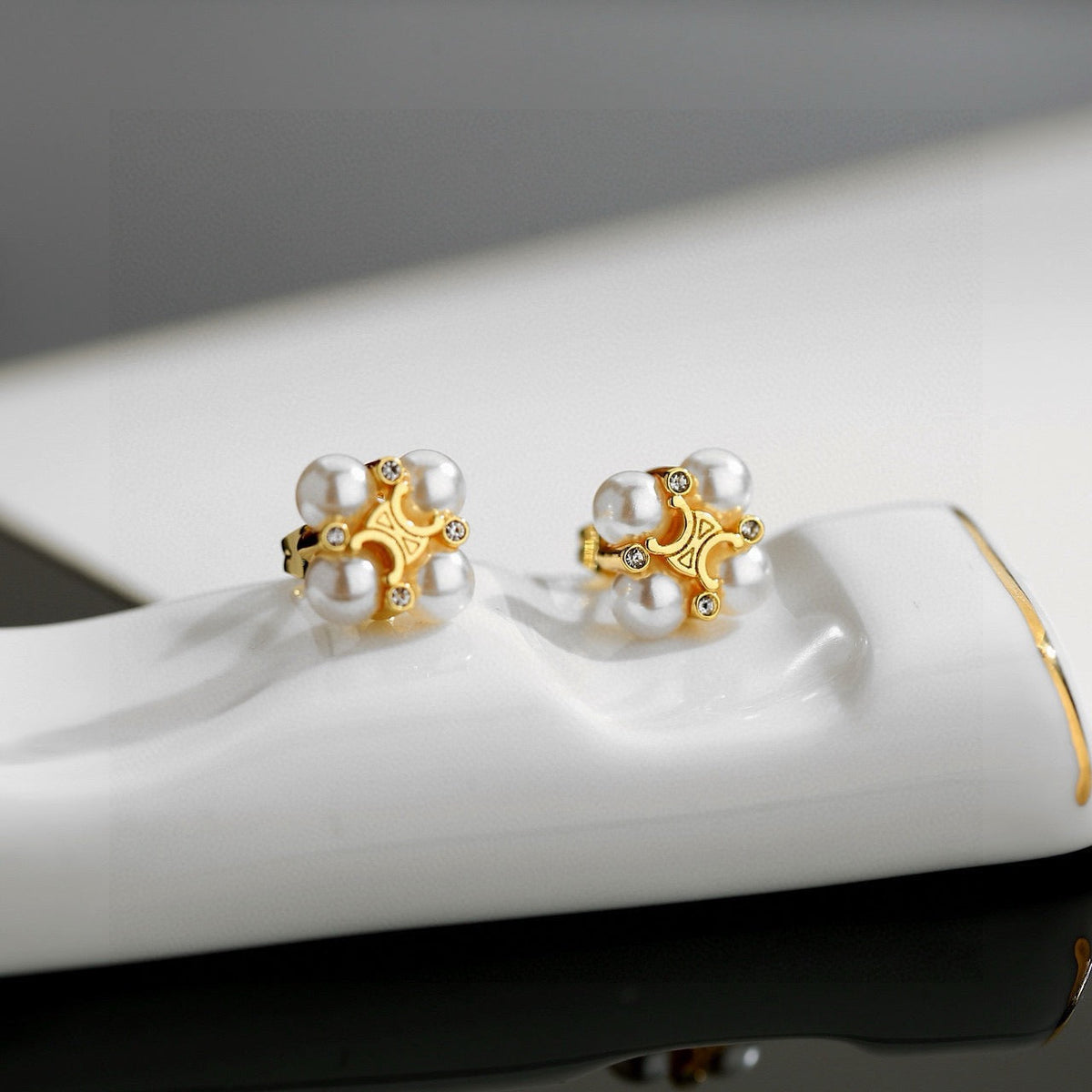 Martin Graham stud earrings in polished metal-tone