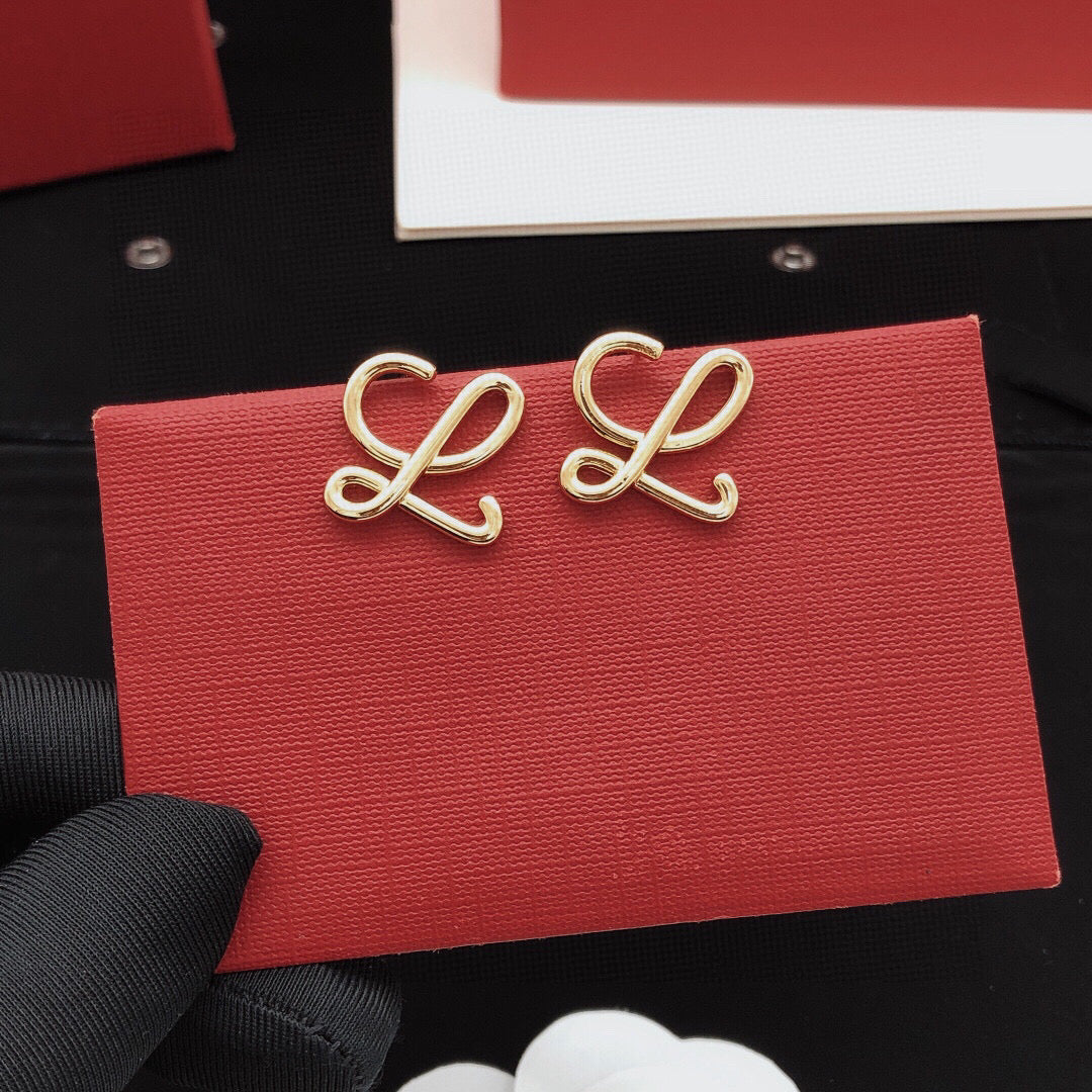 Martin Graham stud earrings in polished metal-tone – close-up detail