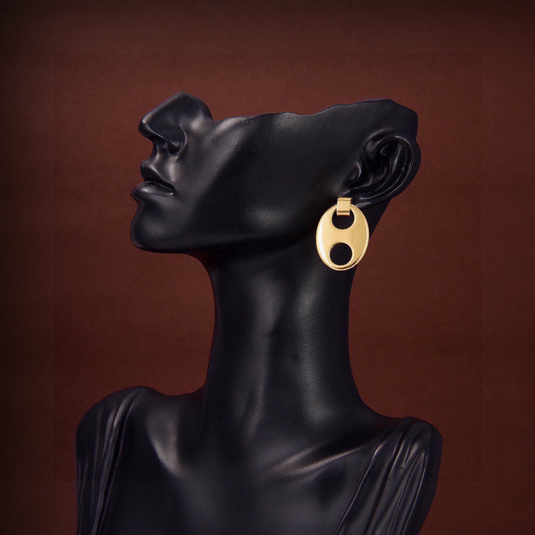 Martin Graham stud earrings in polished metal-tone – close-up detail