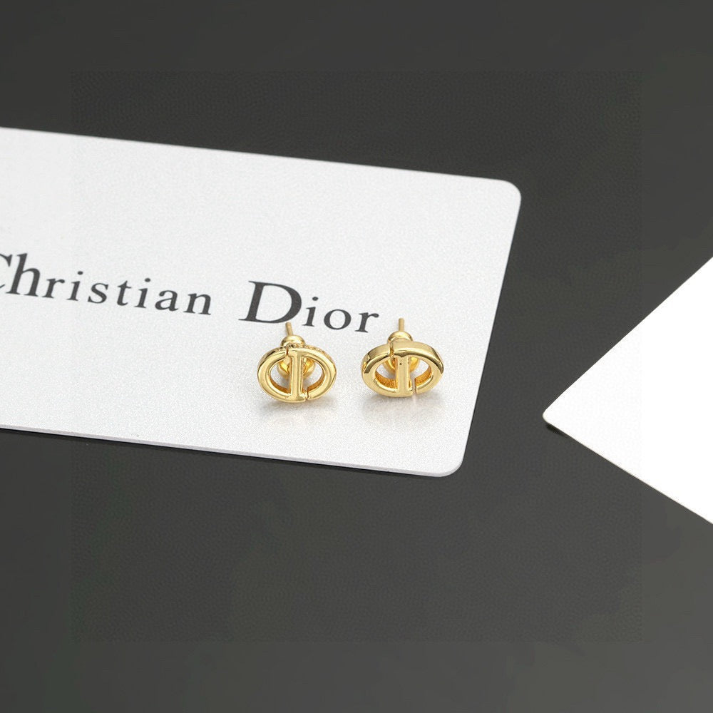 Martin Graham stud earrings in polished metal-tone – close-up detail