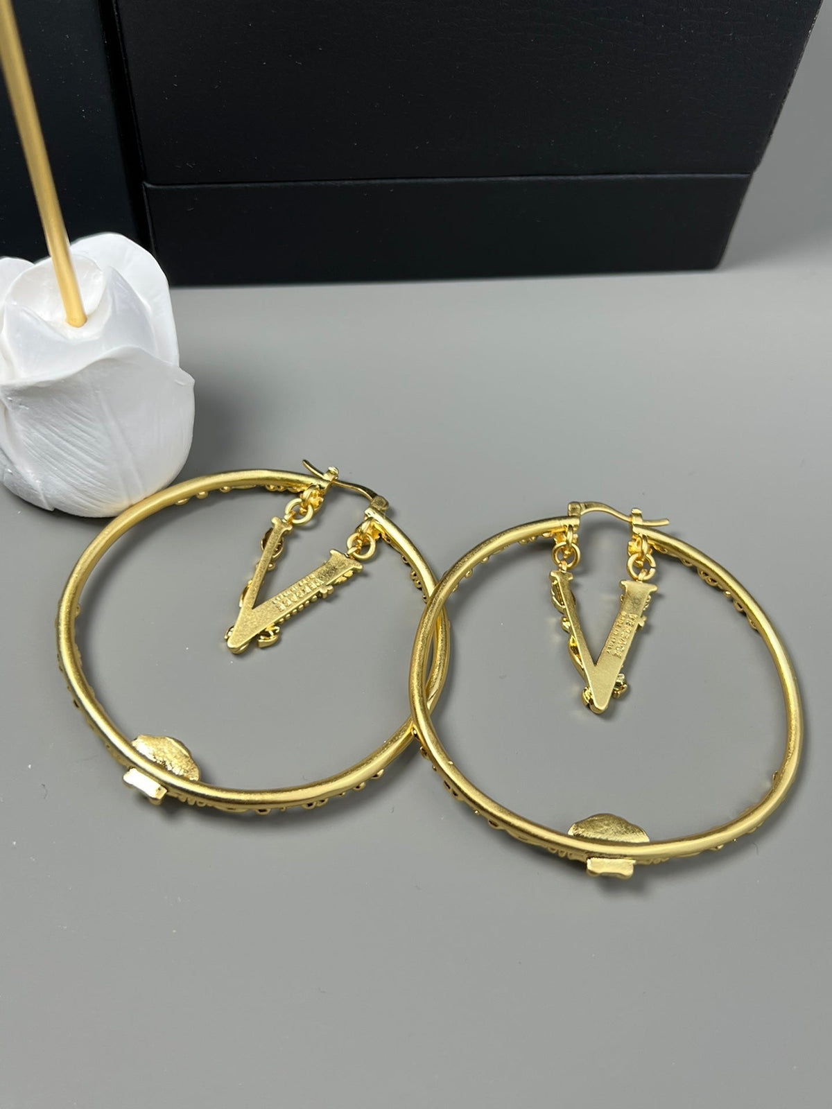 Martin Graham stud earrings in polished metal-tone – close-up detail