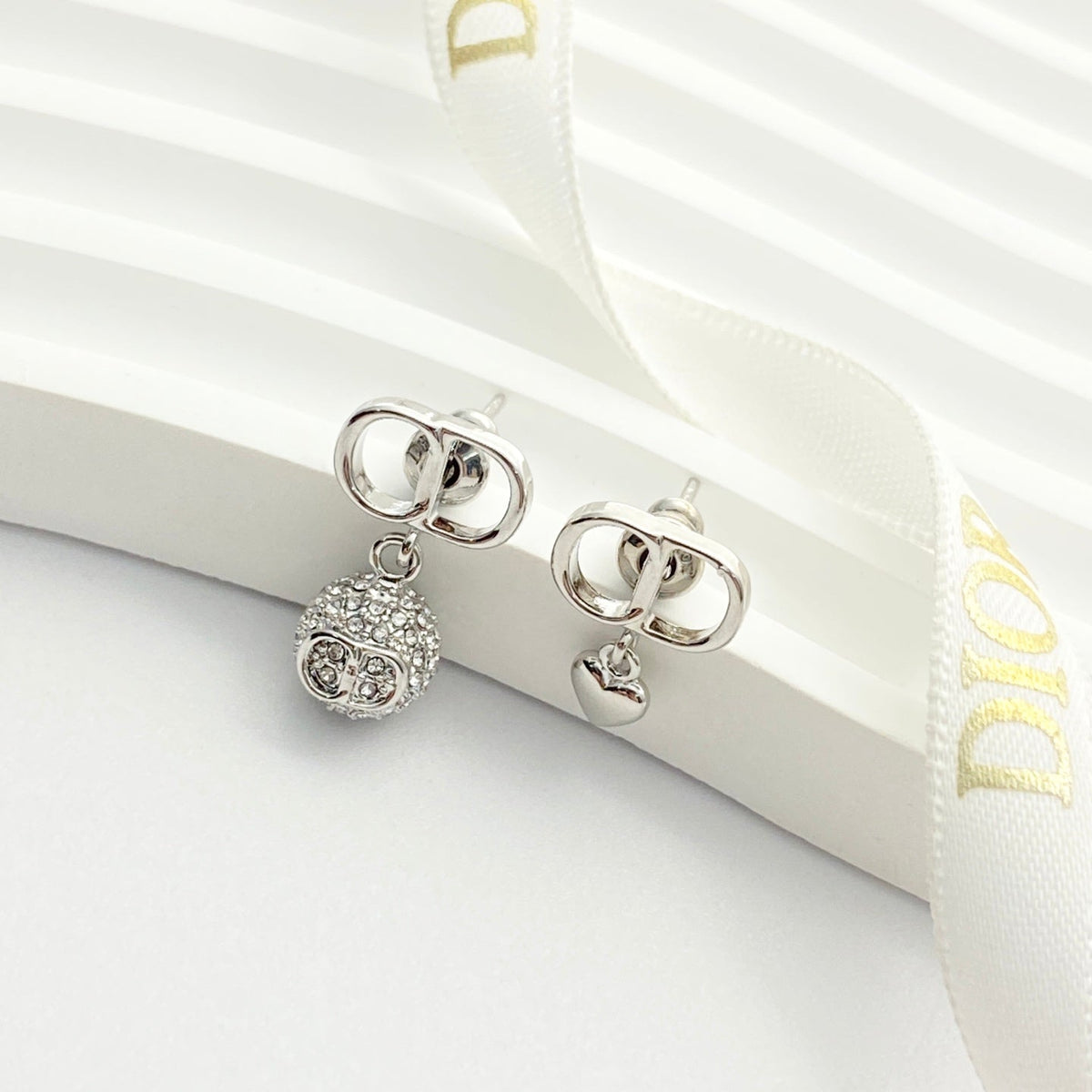 Martin Graham stud earrings in polished metal-tone – close-up detail