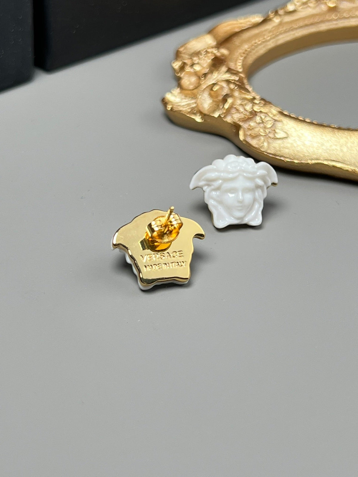Martin Graham stud earrings in polished metal-tone – close-up detail