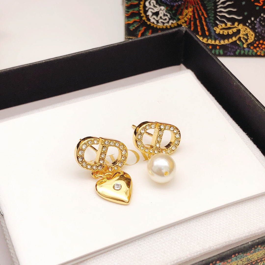 Martin Graham stud earrings in polished metal-tone – close-up detail