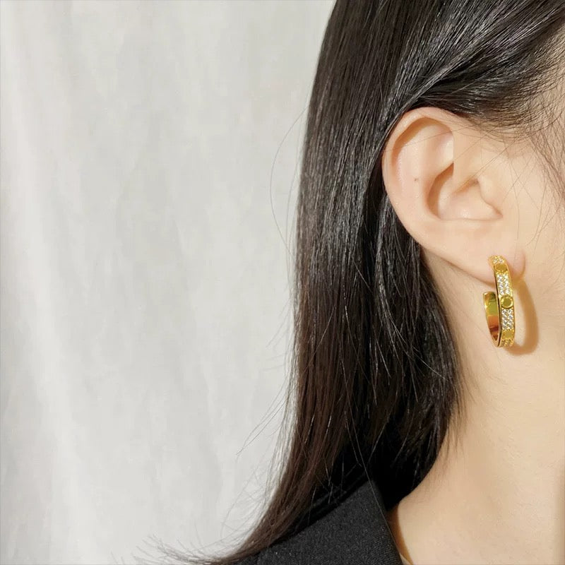 Martin Graham stud earrings in polished metal-tone – front view