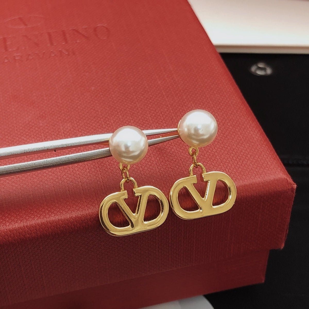 Martin Graham stud earrings in polished metal-tone – front view