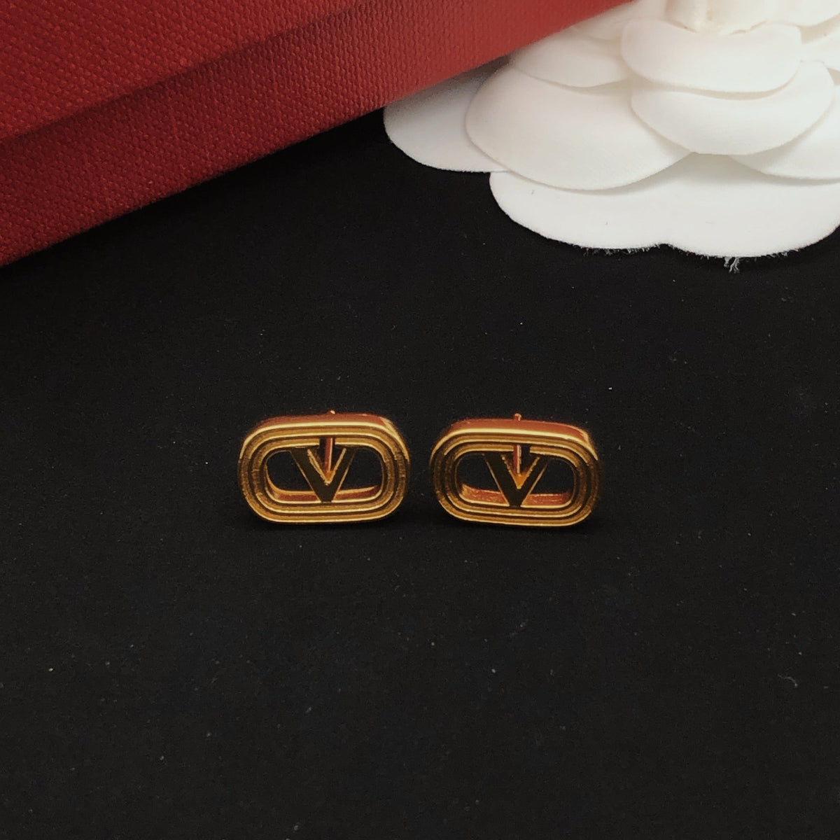Martin Graham stud earrings in polished metal-tone – front view