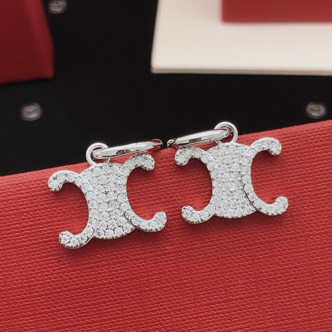 Martin Graham drop earrings in polished metal-tone – front view