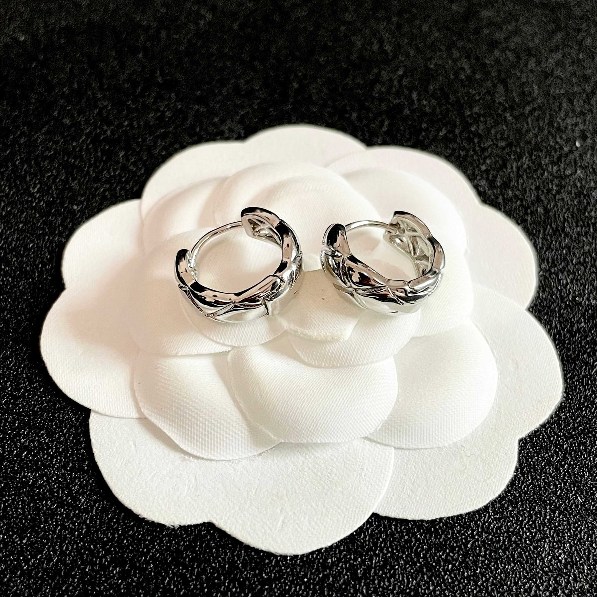 Martin Graham stud earrings in polished metal-tone – front product view
