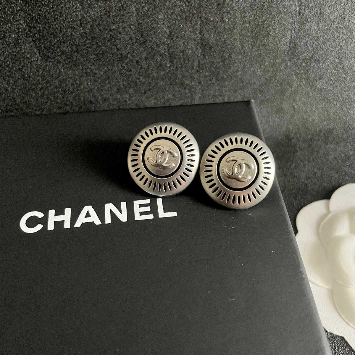 Martin Graham stud earrings in polished metal-tone – detail view