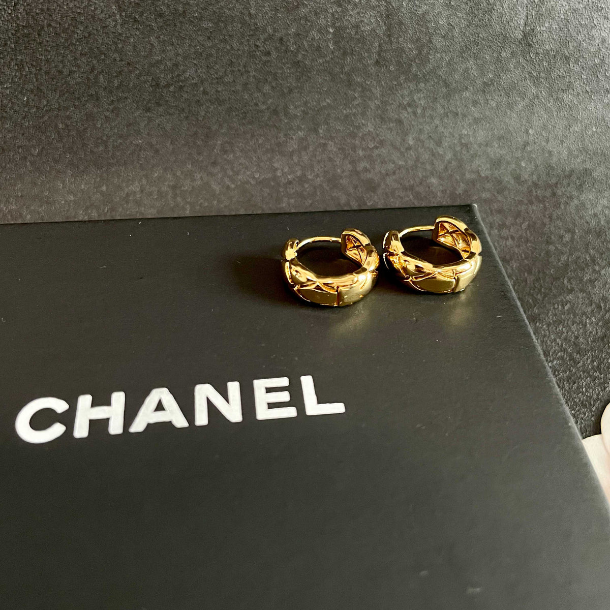 Martin Graham stud earrings in polished metal-tone – detail view