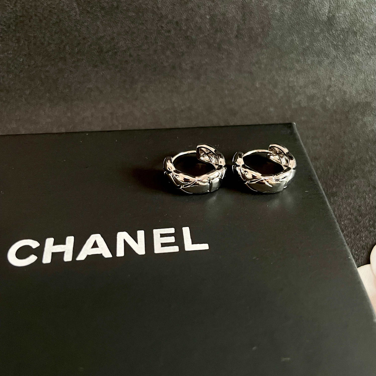 Martin Graham stud earrings in polished metal-tone – detail view